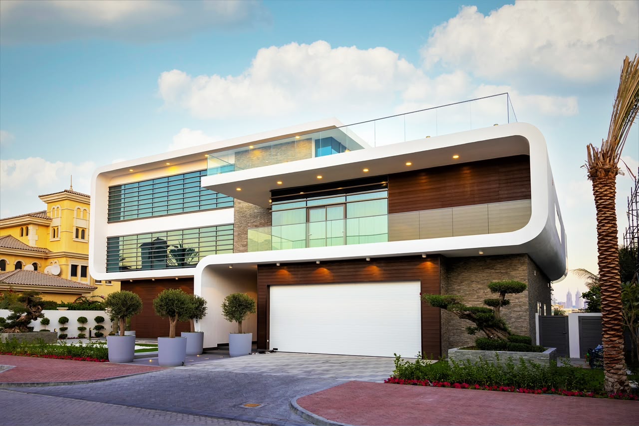 A sleek modern house with large windows and a car parked in the driveway, showcasing contemporary architecture.